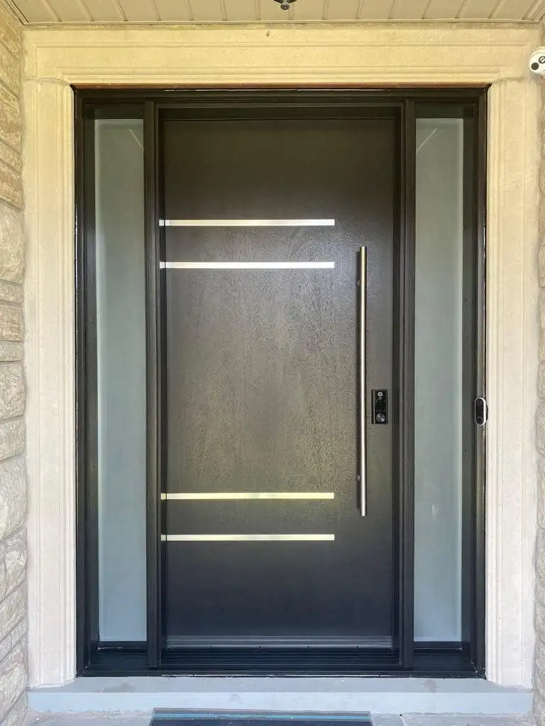 Dark entry door with horizontal stainless bars and two frosted sidelites, in a limestone surround