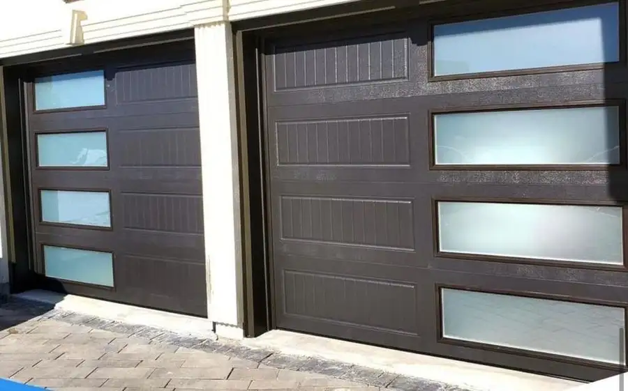 Brown woodgrain garage doors with a column of frosted glass lites, under a white soffit