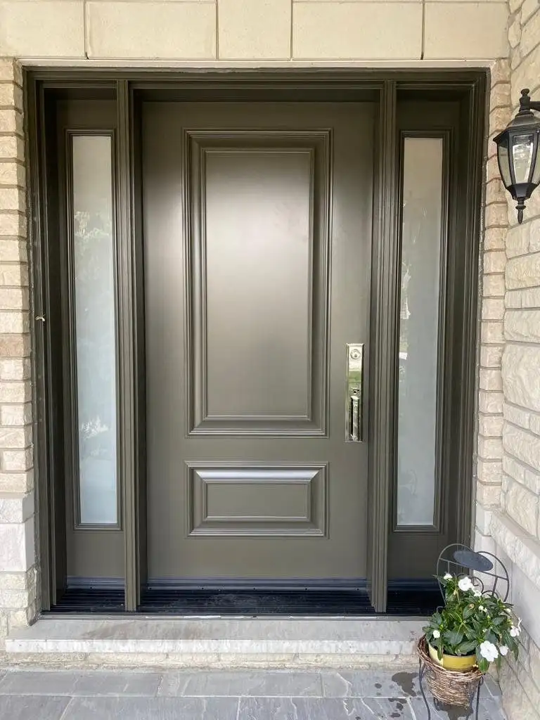 Grey raised-panel entry door with glass sidelites, in a buff brick entrance