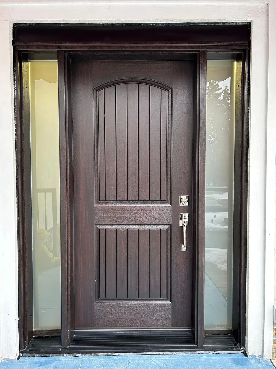 Mahogany-finish entry door with an arched top panel and frosted sidelites, in a white surround