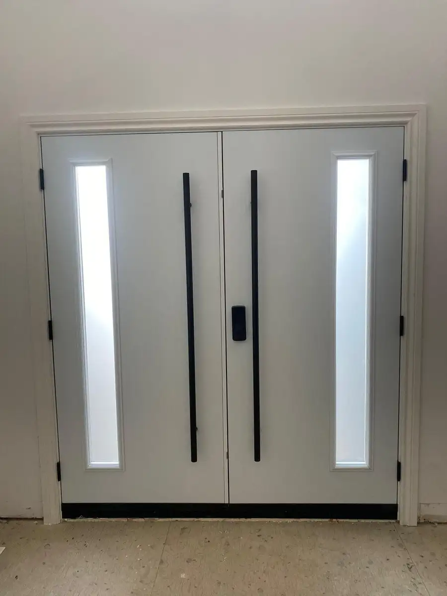 Inside view of a white double door with narrow glass sidelites and long black pulls